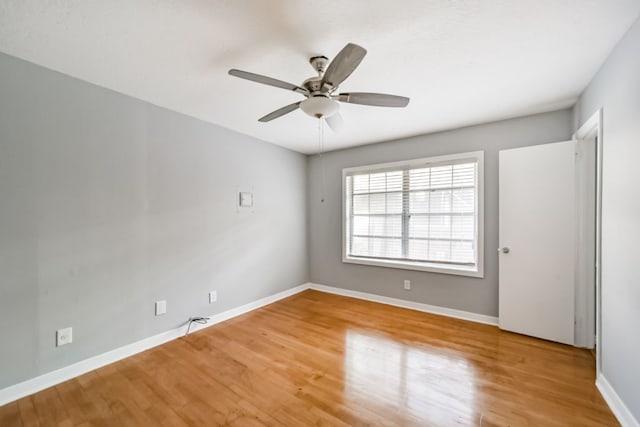 spare room featuring ceiling fan and hardwood / wood-style flooring