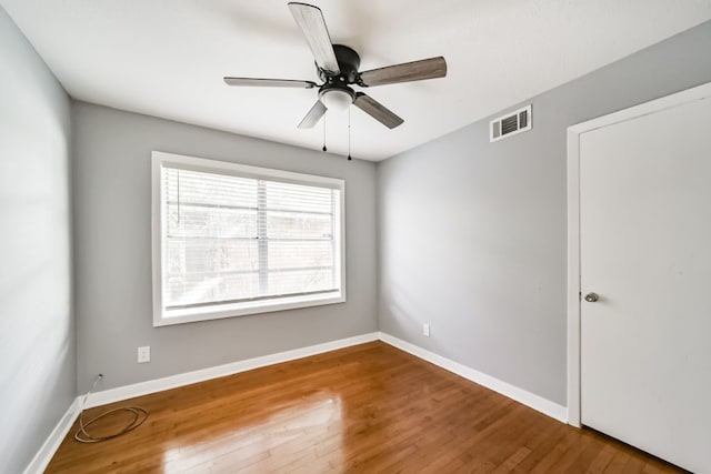 spare room with hardwood / wood-style flooring and ceiling fan