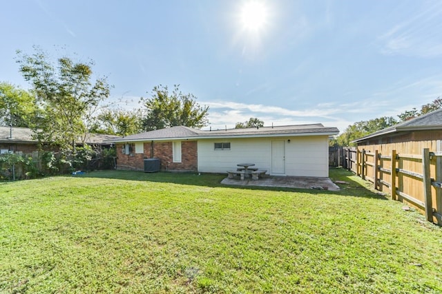 rear view of house with a lawn and a patio