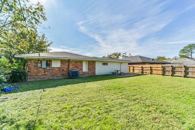 rear view of house featuring a yard and cooling unit