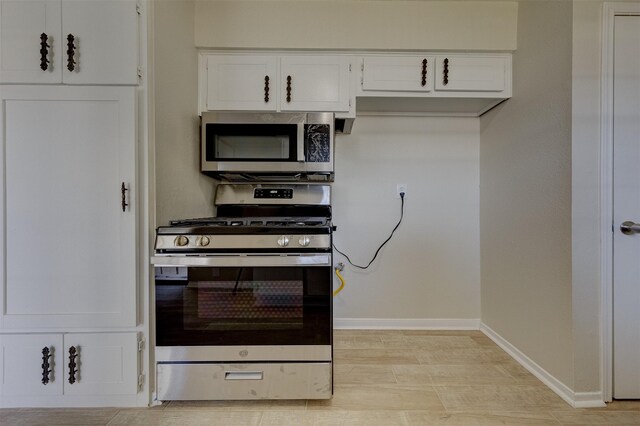 kitchen featuring appliances with stainless steel finishes and white cabinetry