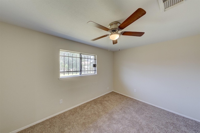 carpeted empty room featuring ceiling fan