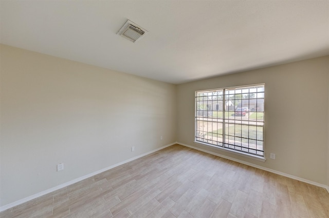 unfurnished room featuring light hardwood / wood-style floors