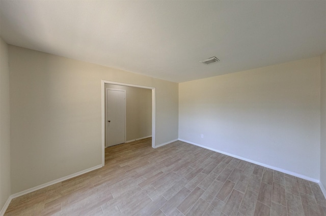 spare room with light hardwood / wood-style flooring