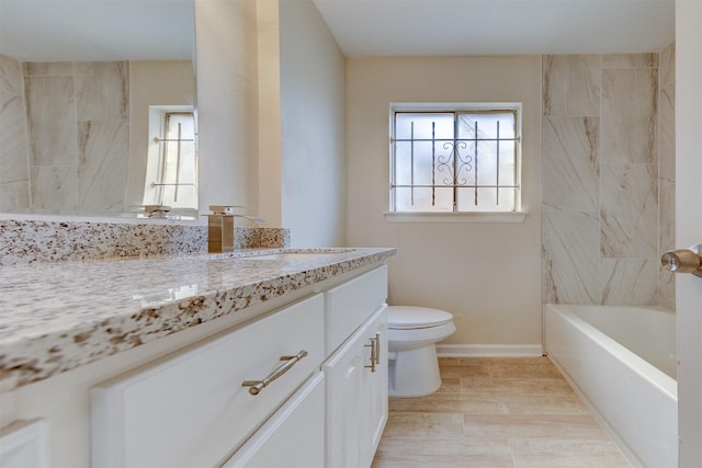 bathroom featuring vanity, hardwood / wood-style flooring, and toilet