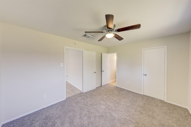 unfurnished bedroom with light colored carpet and ceiling fan