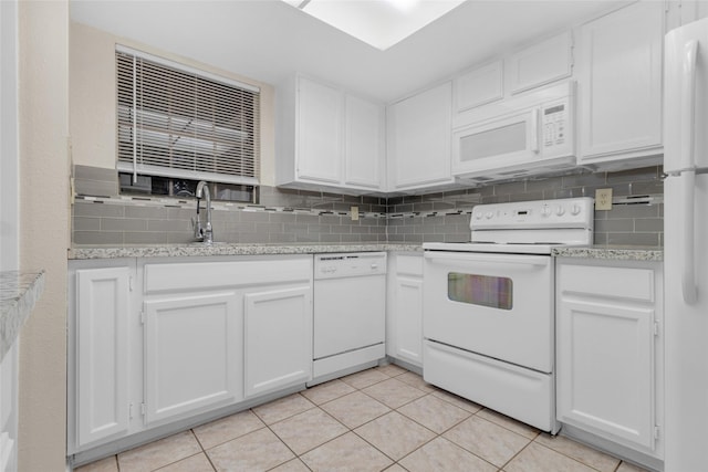 kitchen with decorative backsplash, white cabinets, and white appliances