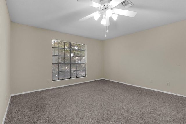 carpeted spare room featuring ceiling fan