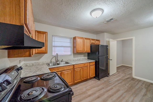 kitchen featuring black refrigerator, light wood-type flooring, a textured ceiling, sink, and electric range