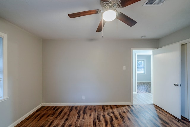 spare room with ceiling fan and dark hardwood / wood-style flooring