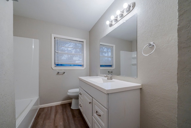 full bathroom with vanity, toilet, wood-type flooring, and shower / tub combination