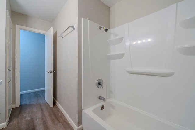 bathroom featuring hardwood / wood-style flooring and shower / bathing tub combination