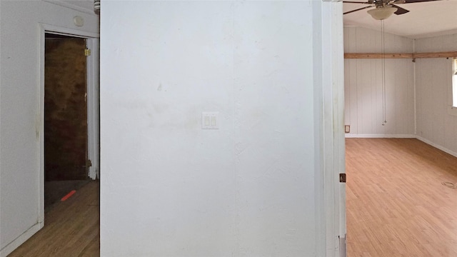 hallway with wood-type flooring and lofted ceiling