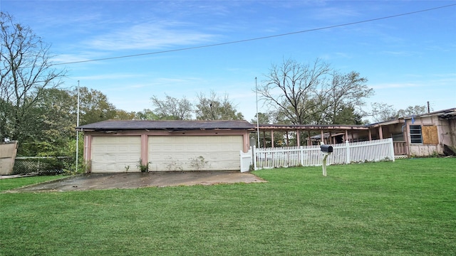 exterior space with a garage, an outbuilding, and a front yard