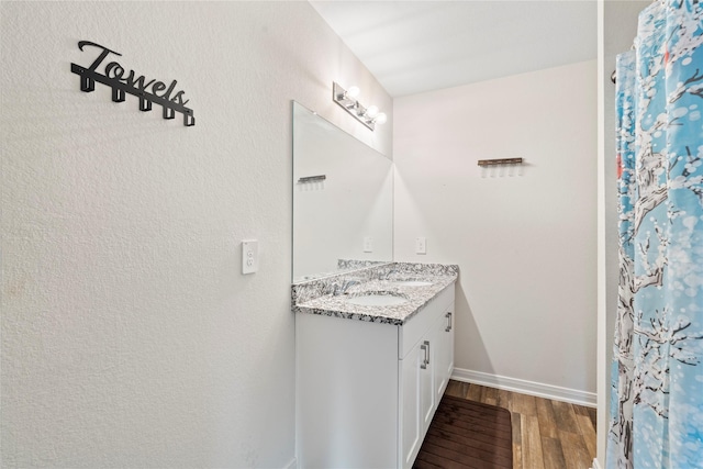 bathroom with vanity and hardwood / wood-style flooring