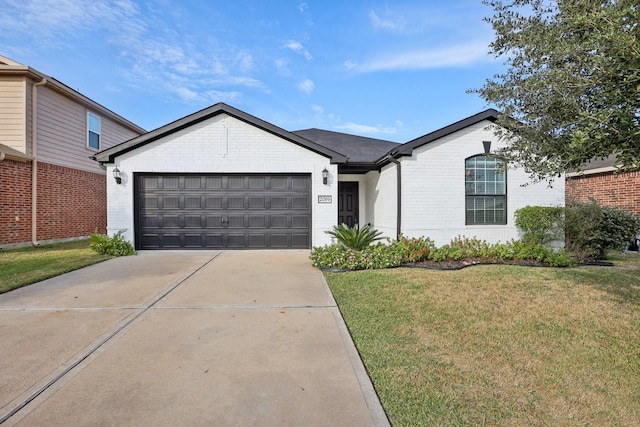 ranch-style house featuring a front yard and a garage