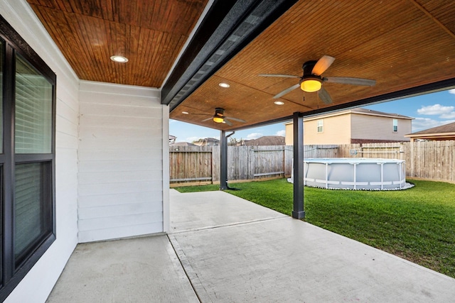 view of patio / terrace with a fenced in pool and ceiling fan