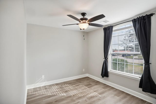 empty room with ceiling fan and wood-type flooring