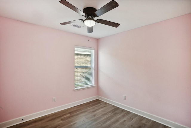 spare room featuring ceiling fan and dark hardwood / wood-style floors