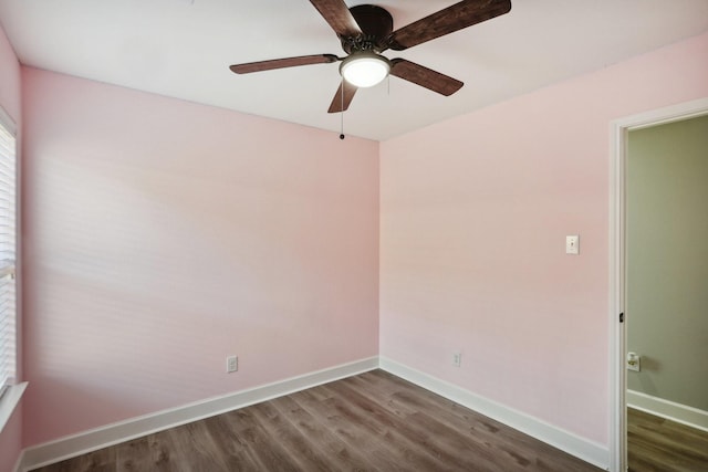 unfurnished room with dark hardwood / wood-style floors and ceiling fan