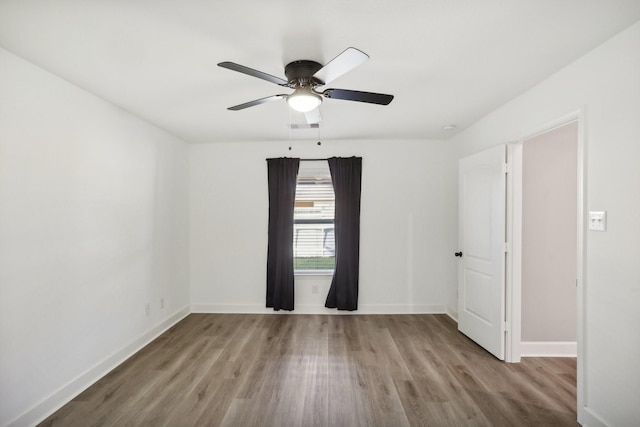 empty room featuring ceiling fan and light wood-type flooring