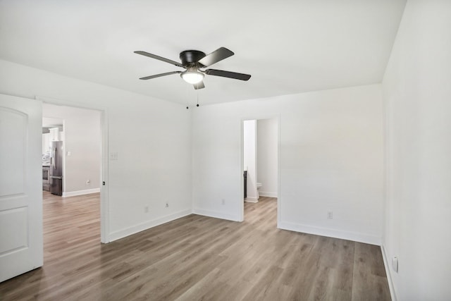 unfurnished room featuring ceiling fan and light hardwood / wood-style floors