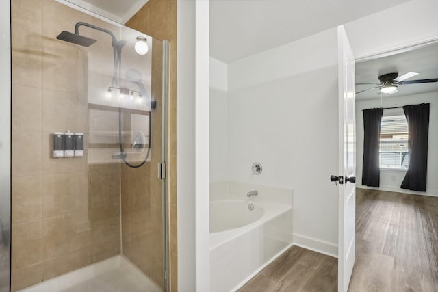 bathroom featuring hardwood / wood-style floors, ceiling fan, and shower with separate bathtub