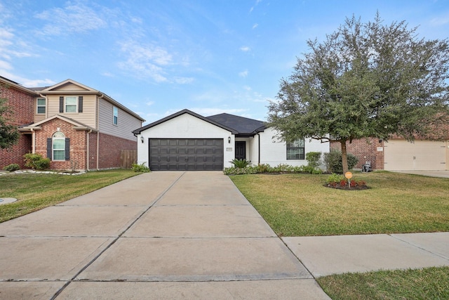 view of front of house featuring a garage and a front lawn