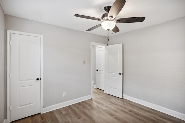 unfurnished bedroom featuring ceiling fan and light hardwood / wood-style floors