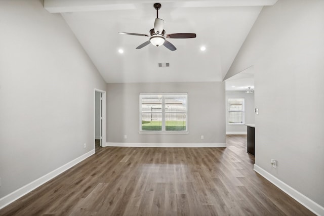 unfurnished living room with hardwood / wood-style floors, ceiling fan, and high vaulted ceiling