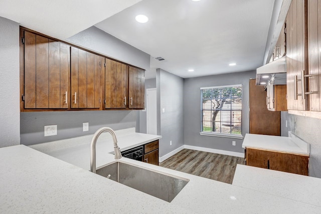 kitchen with sink, light hardwood / wood-style floors, and extractor fan