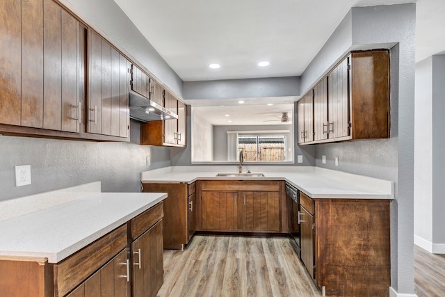 kitchen with sink, light wood-type flooring, dishwasher, and ceiling fan