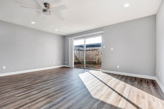 spare room featuring dark wood-type flooring and ceiling fan