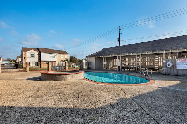 view of swimming pool with a community hot tub and a patio