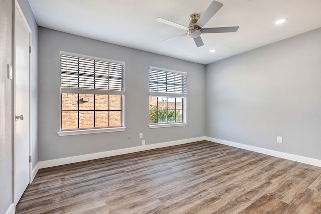 unfurnished room with ceiling fan and hardwood / wood-style floors