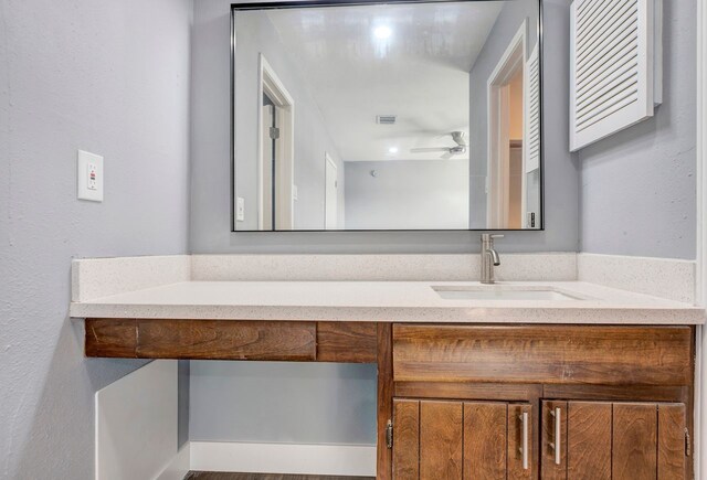 bathroom with ceiling fan and vanity