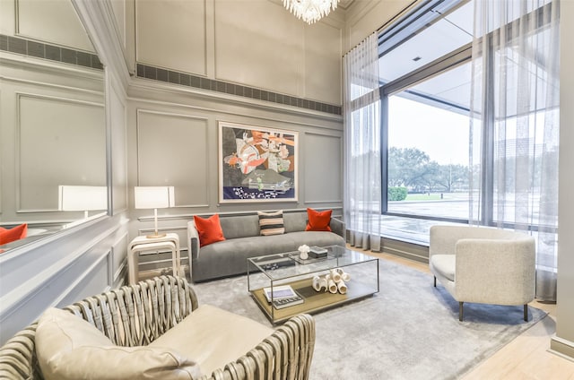 living room featuring light wood-type flooring and an inviting chandelier