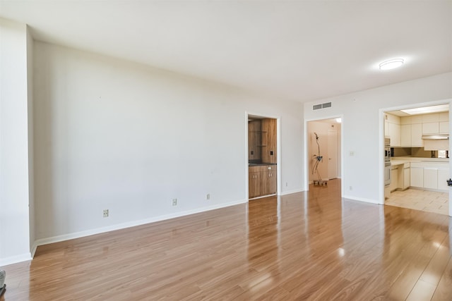 unfurnished living room featuring light hardwood / wood-style floors