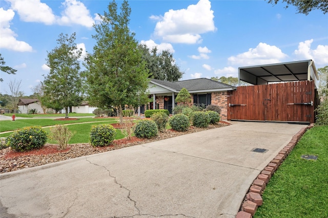 view of front facade with a carport and a front yard