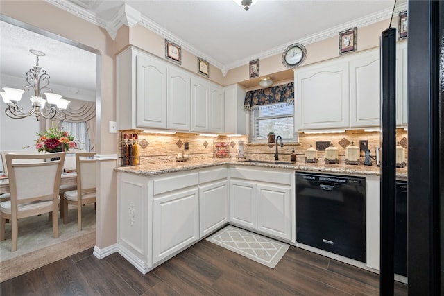 kitchen featuring sink, black dishwasher, white cabinetry, and hanging light fixtures