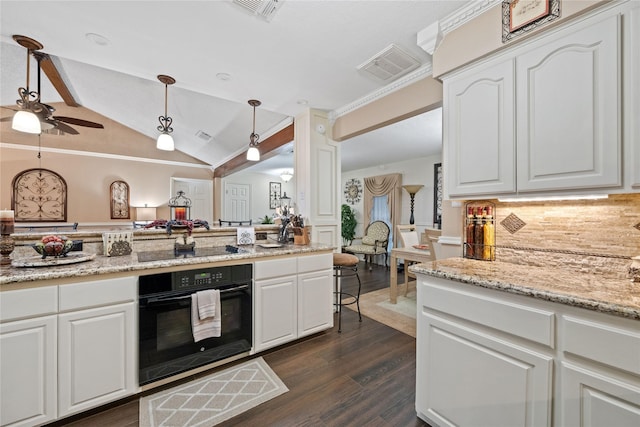 kitchen featuring vaulted ceiling, pendant lighting, black appliances, backsplash, and white cabinetry