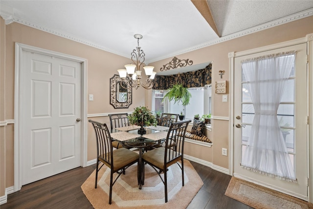 dining room featuring a textured ceiling, crown molding, a chandelier, and dark hardwood / wood-style floors