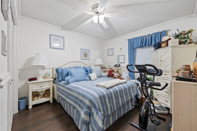 bedroom with ceiling fan, dark wood-type flooring, crown molding, and a textured ceiling