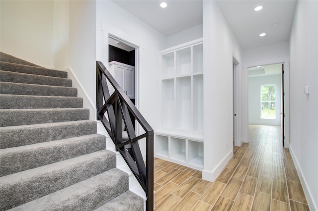 stairway with hardwood / wood-style flooring