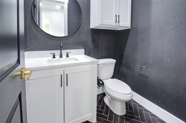 bathroom featuring tile patterned floors, vanity, and toilet