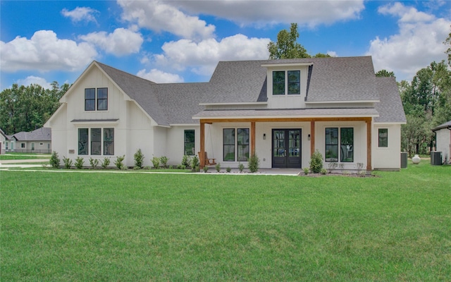 view of front facade with french doors, a front lawn, and central AC unit