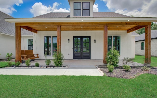 back of house with a yard and french doors