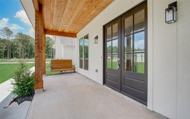 view of patio / terrace with french doors and a porch