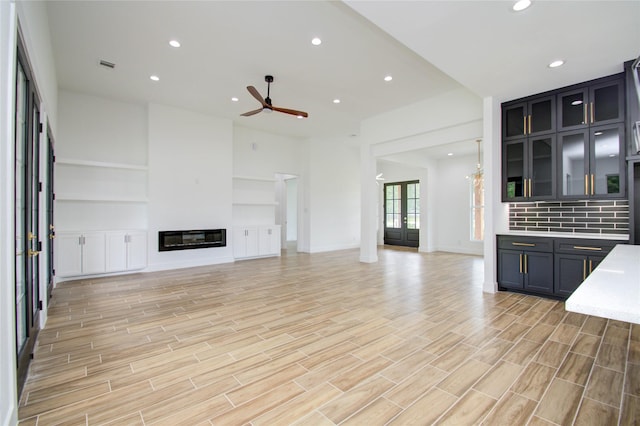 unfurnished living room with ceiling fan and light hardwood / wood-style flooring