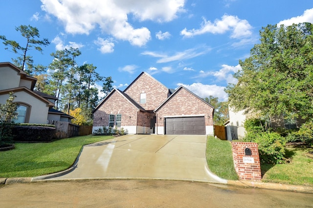 view of front property featuring a garage and a front lawn